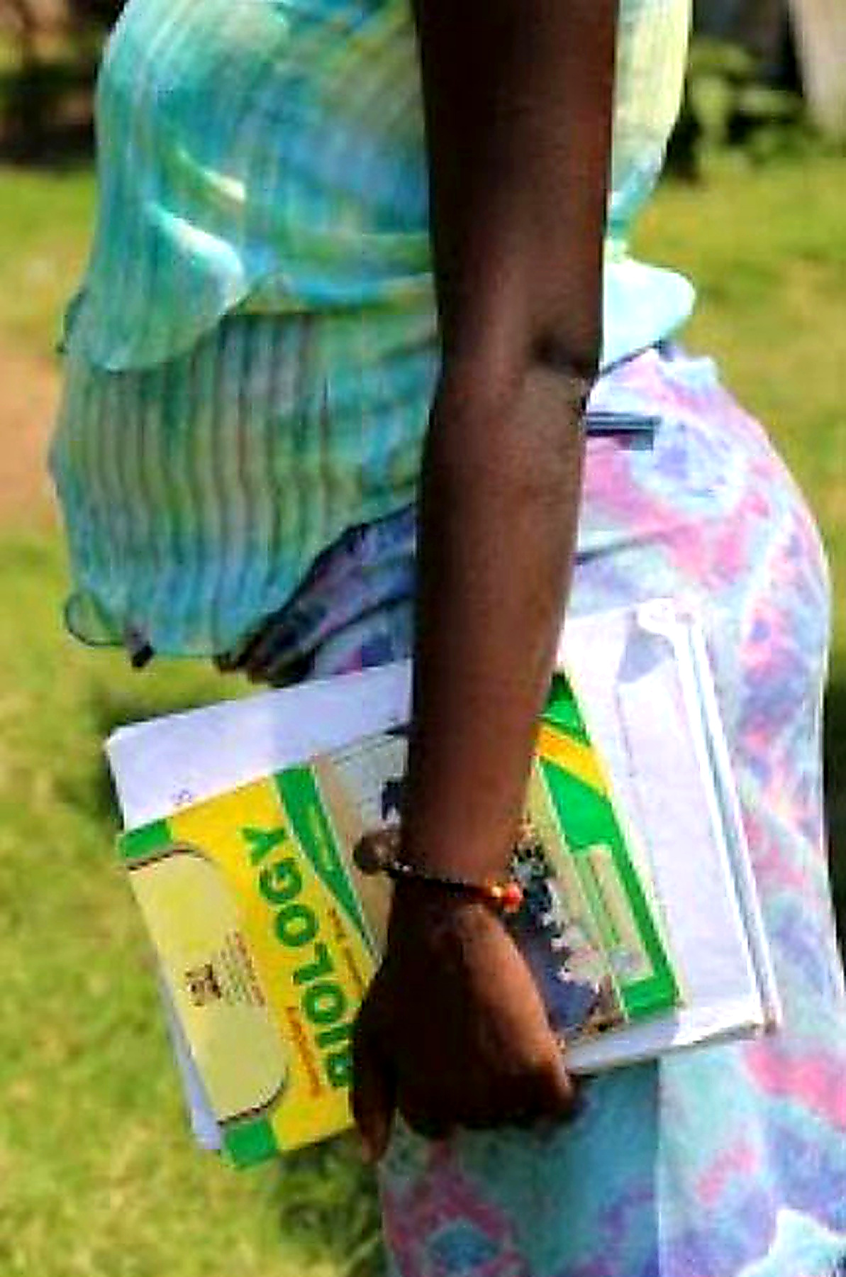 Pregnant student carrying books